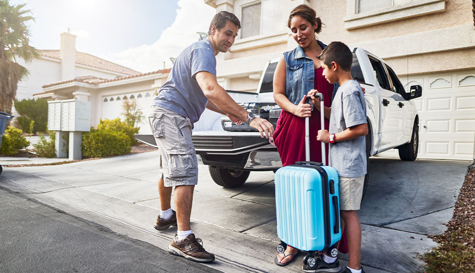 A family leaving for vacation at their driveway